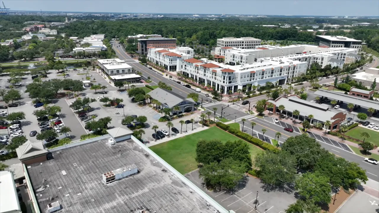 Aerial drone view of Summerville town center with mixed‑use buildings, parking lots, and park area
