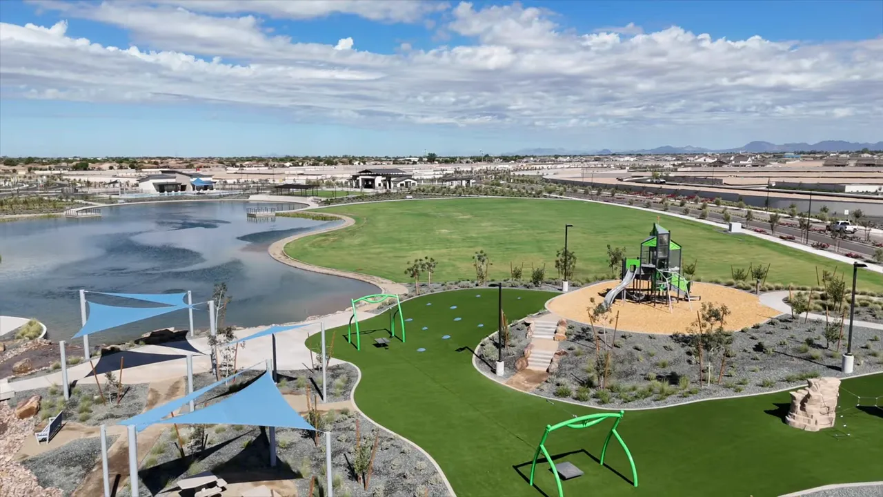 Large community lake with green park space and playground equipment