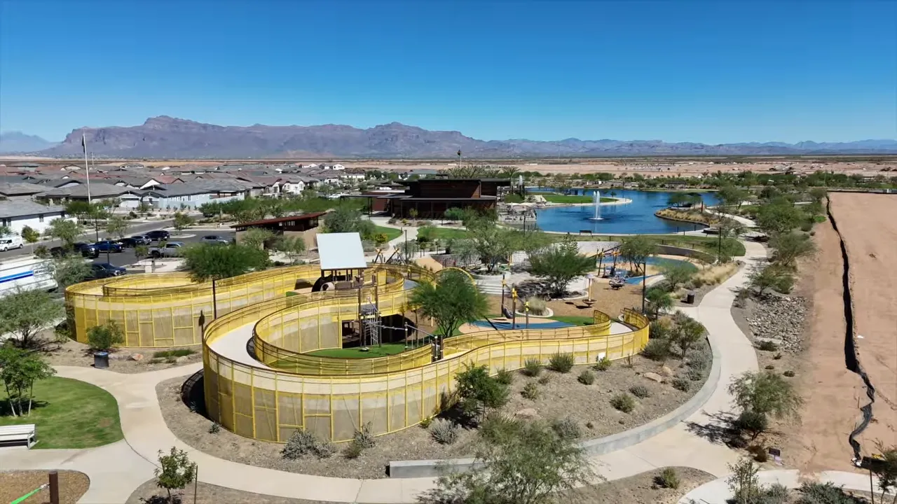 Aerial view of park spaces, paths, water features, and surrounding homes