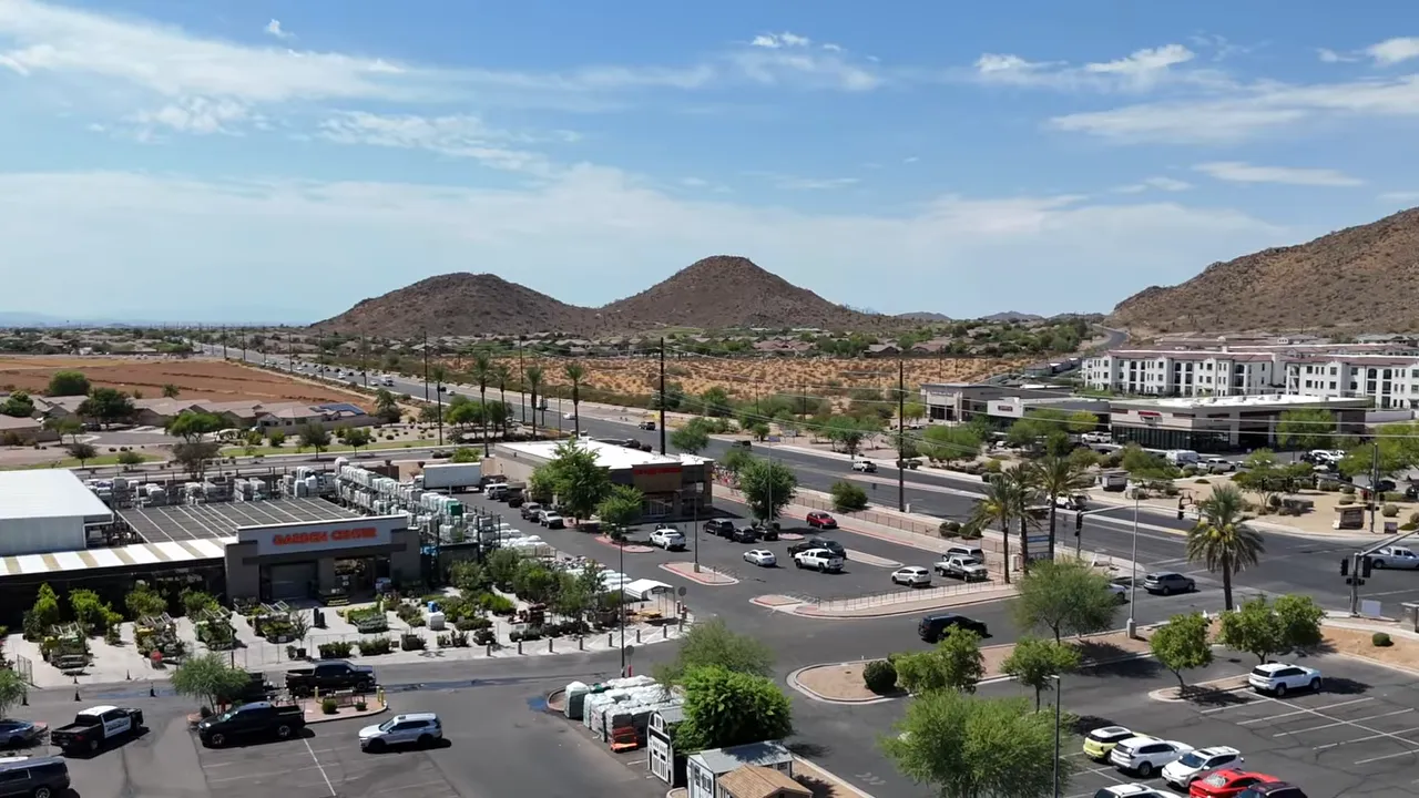 Aerial view of a shopping center with mountains in the background