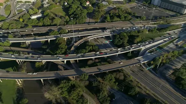 Aerial view of a multi level highway interchange with moving traffic