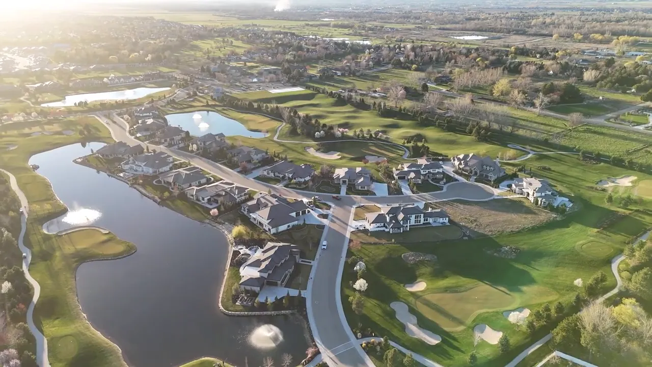 aerial view of golf course community with ponds and homes
