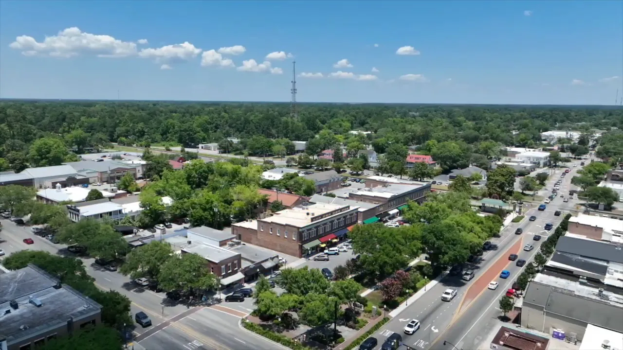 Aerial view of Summerville downtown with shops, streets, trees and cars on a sunny day