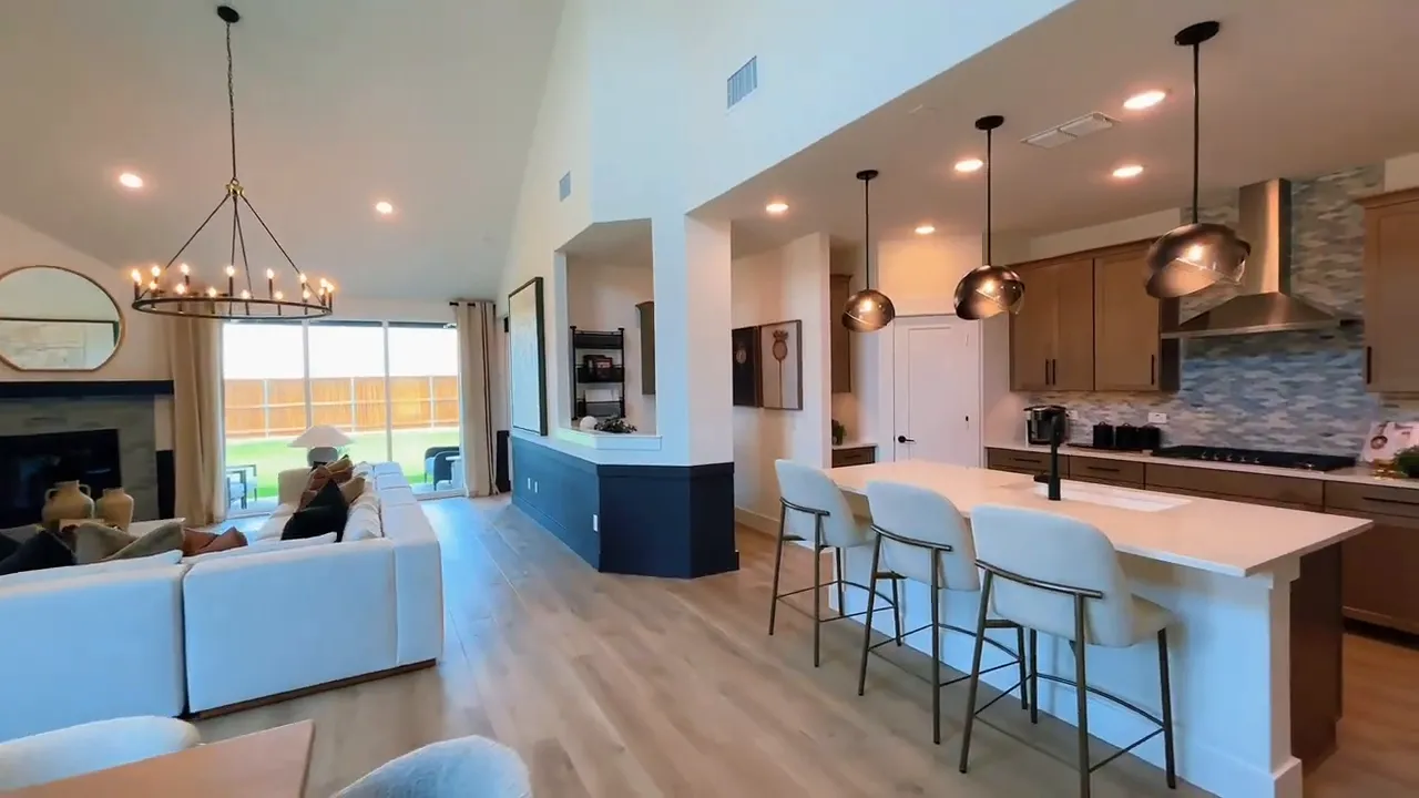 Wide view of dining area, living room, and kitchen in one open-concept space