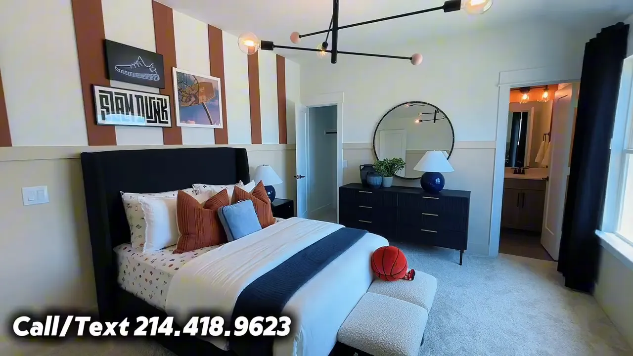 Upstairs bedroom with attached bath entry, large windows, and dark curtains