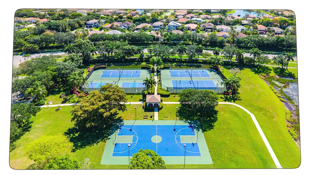 Aerial view of Isles at Wellington clubhouse and pool on a large green peninsula
