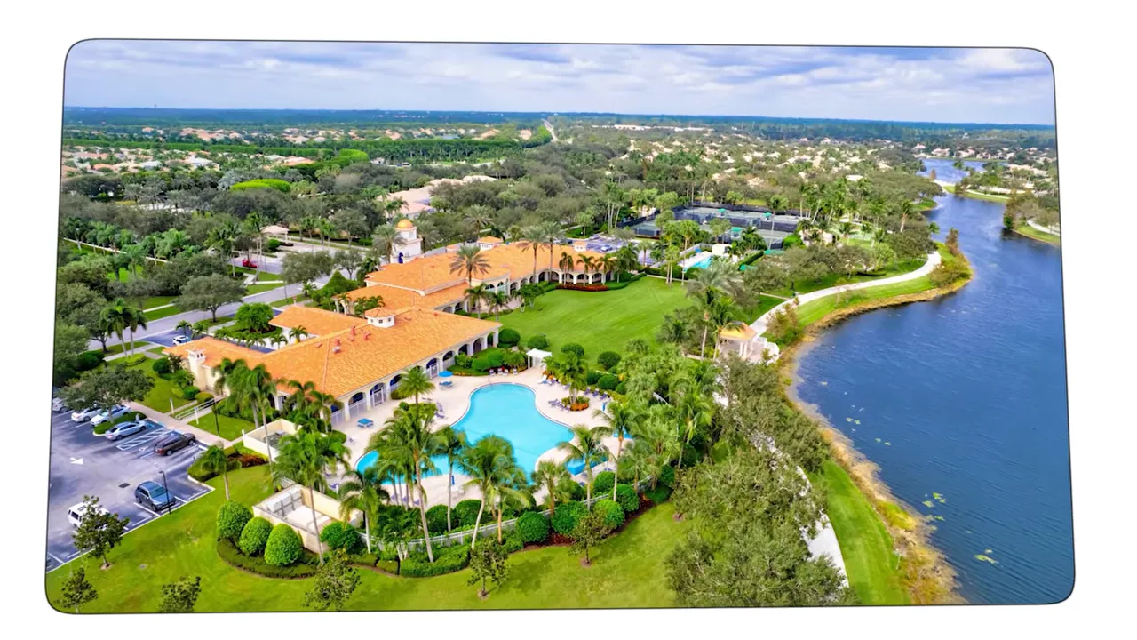 Aerial view of VillageWalk town center pool and clubhouse beside a lake