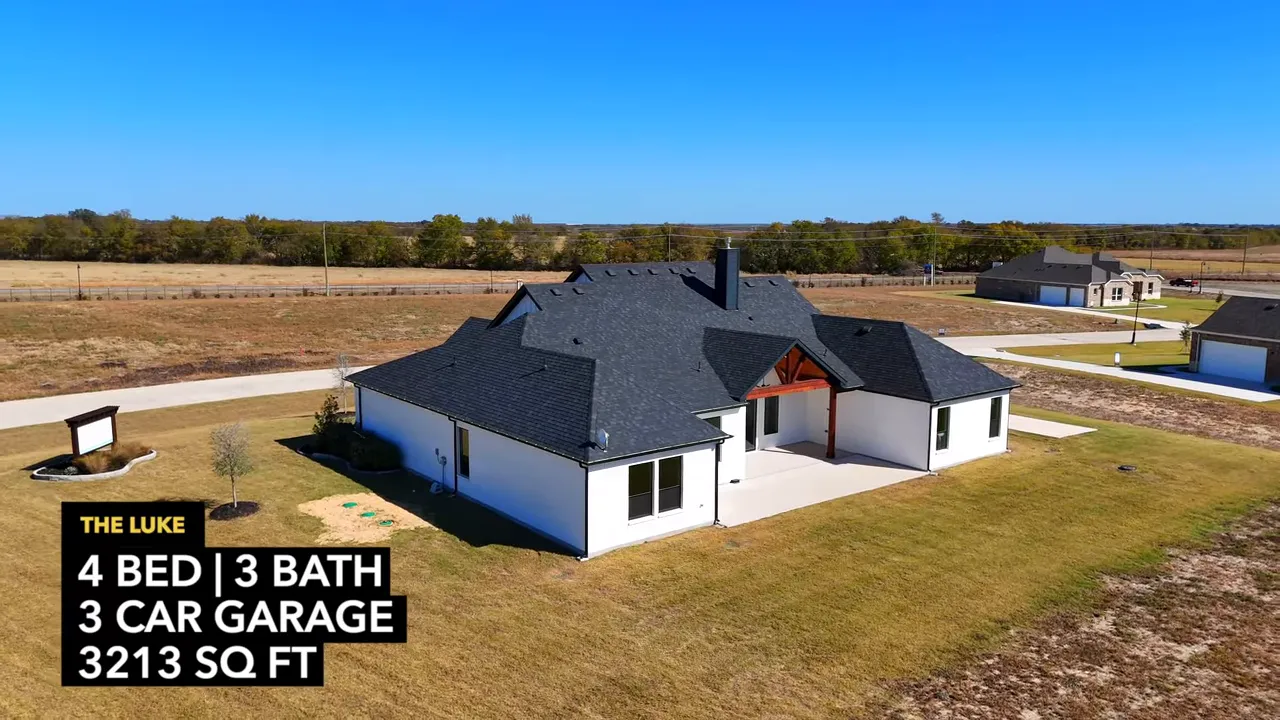 Rear elevation drone view of the Luke farmhouse with covered patio and visible timber gable