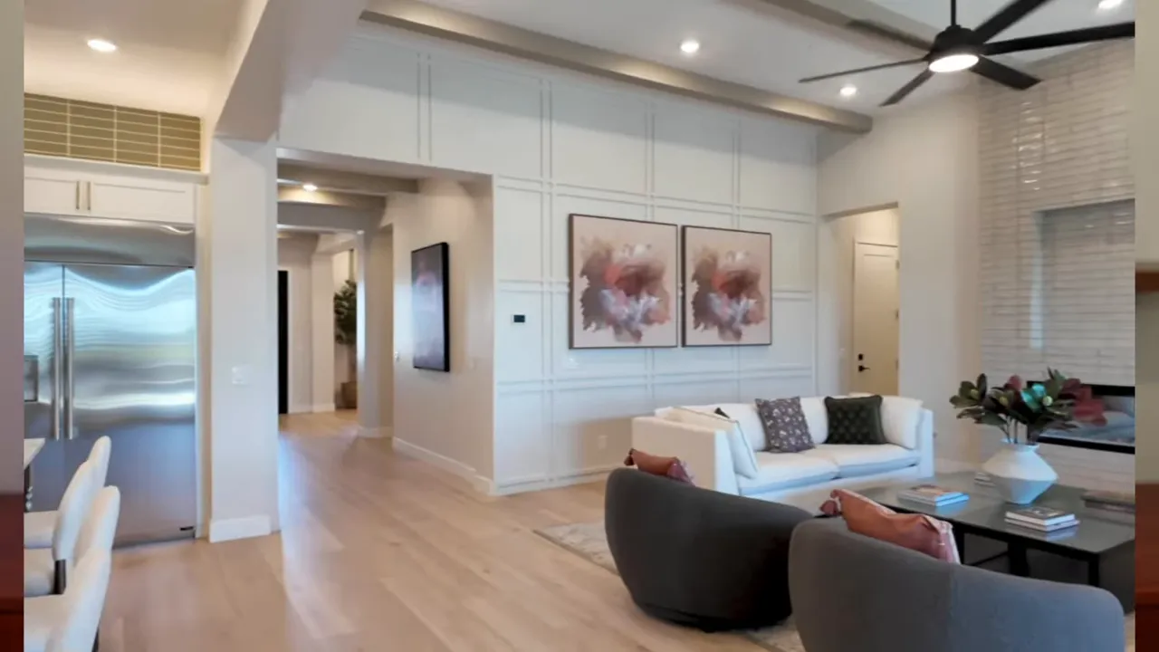 Modern open kitchen and living room with tall ceiling and large island