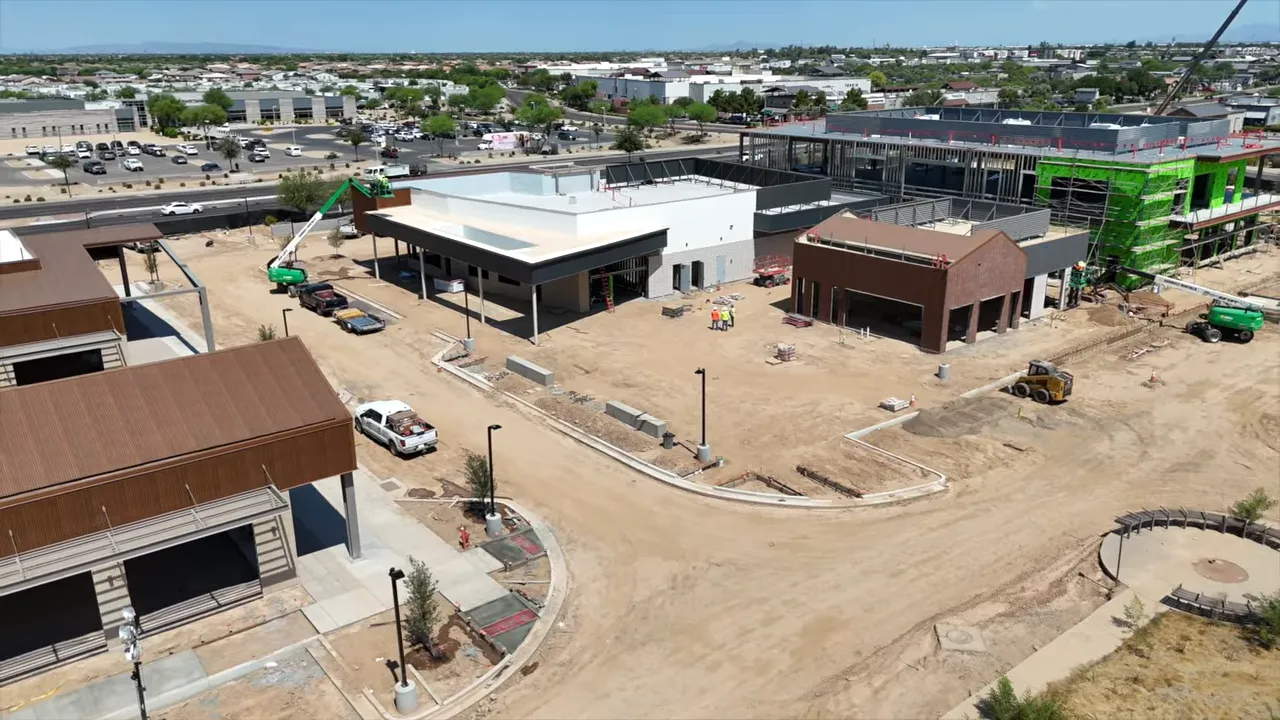 Aerial view of mixed use development construction with retail buildings