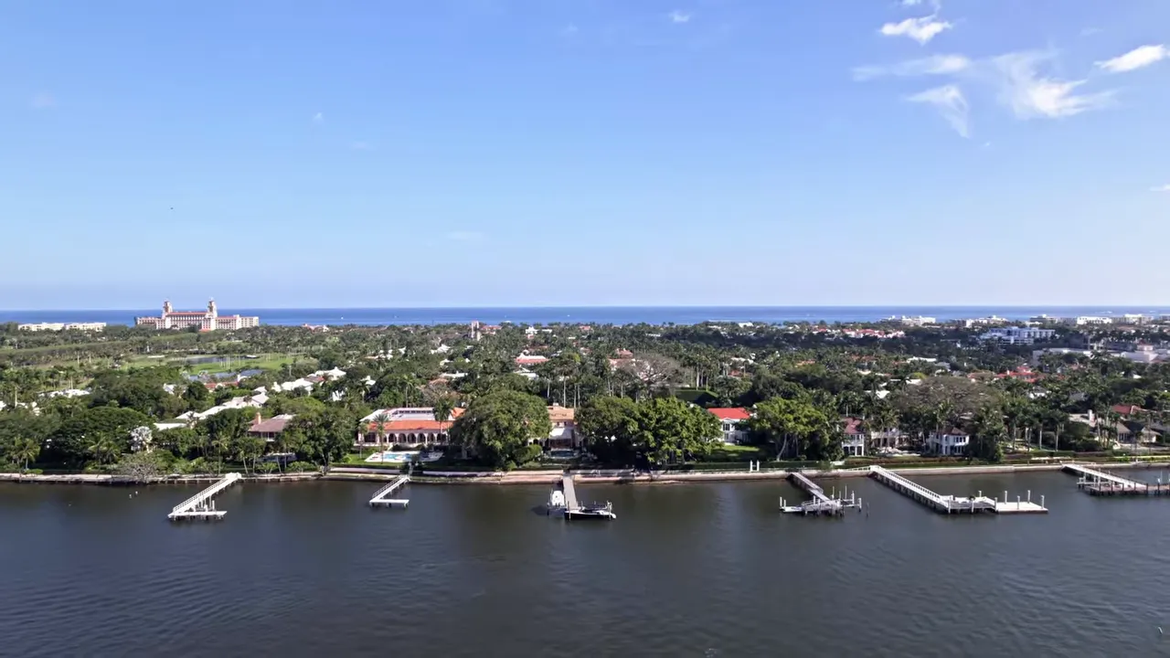 Aerial view of Palm Beach coastline with gated-looking estates and private marina docks