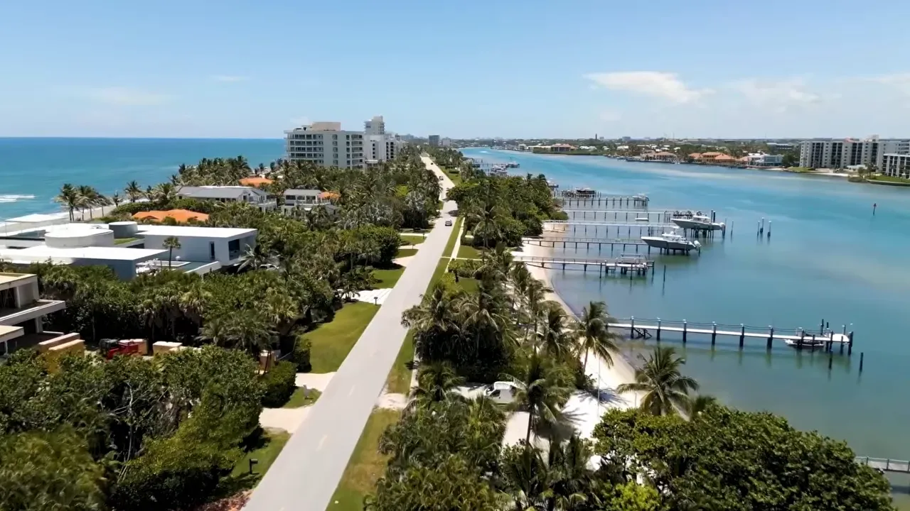 Aerial view of a South Florida waterfront luxury property with a private marina and dock slips