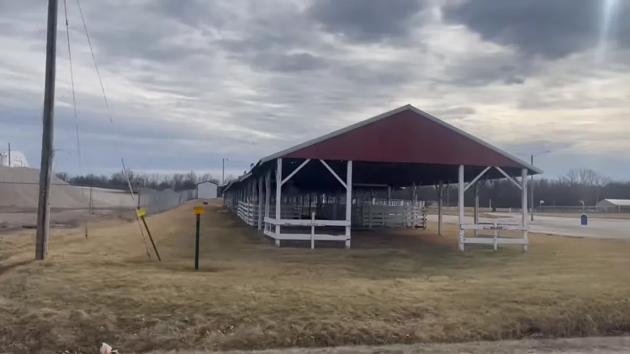 Covered farm livestock barn and fencing on land near Holden, Missouri