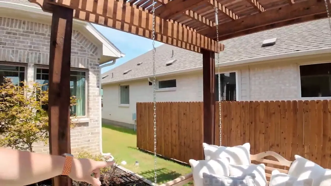 Tuscana courtyard patio swing area with fenced backyard space