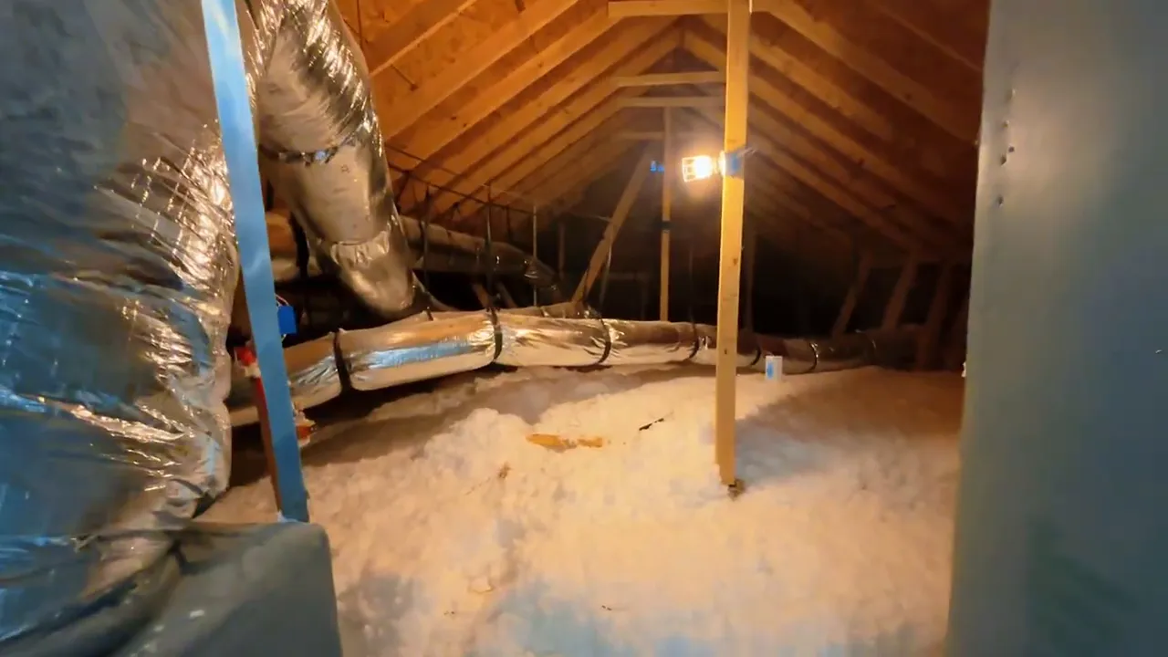 Attic interior with insulation ductwork and framing