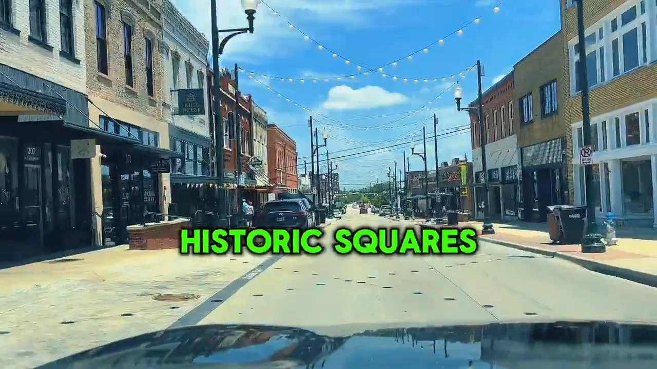 Street scene in downtown McKinney with shops and string lights overhead