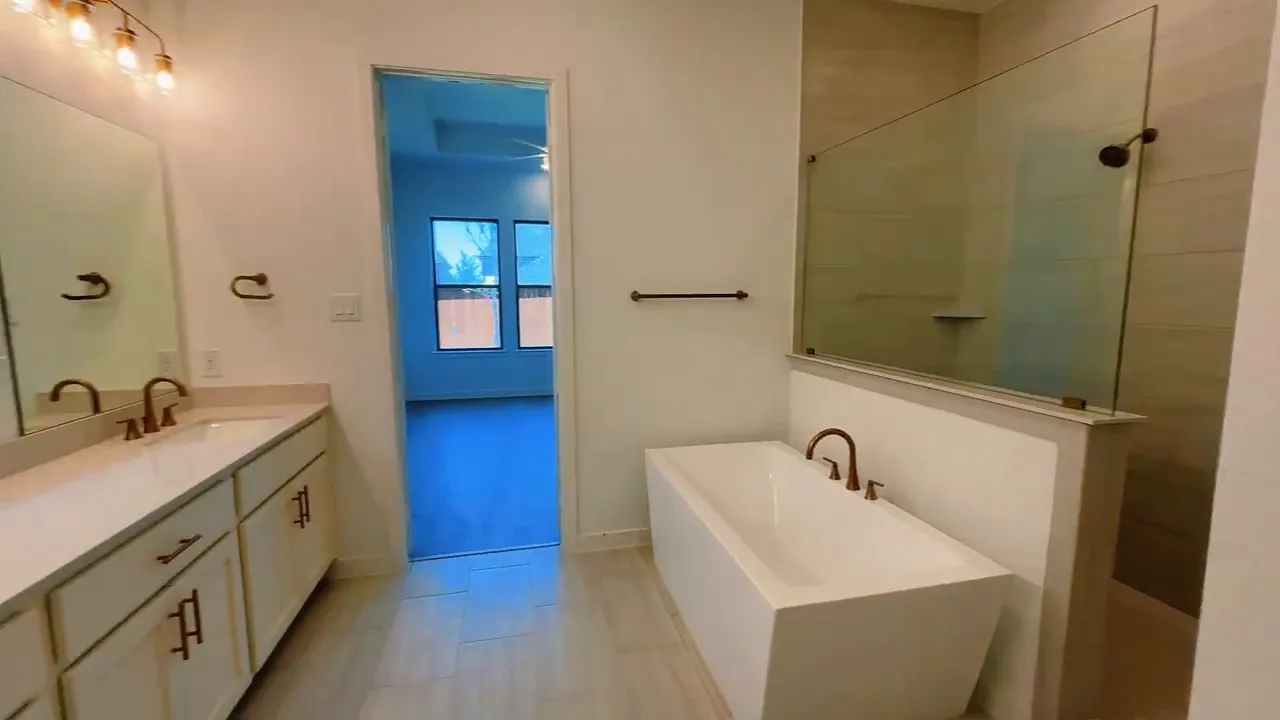 Primary bathroom with double vanity freestanding tub and large shower