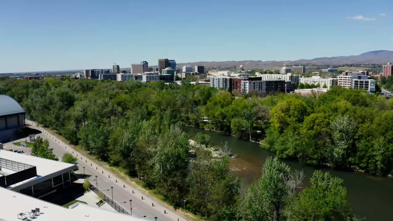 Aerial view of the Boise River Greenbelt with surrounding trees and the downtown skyline