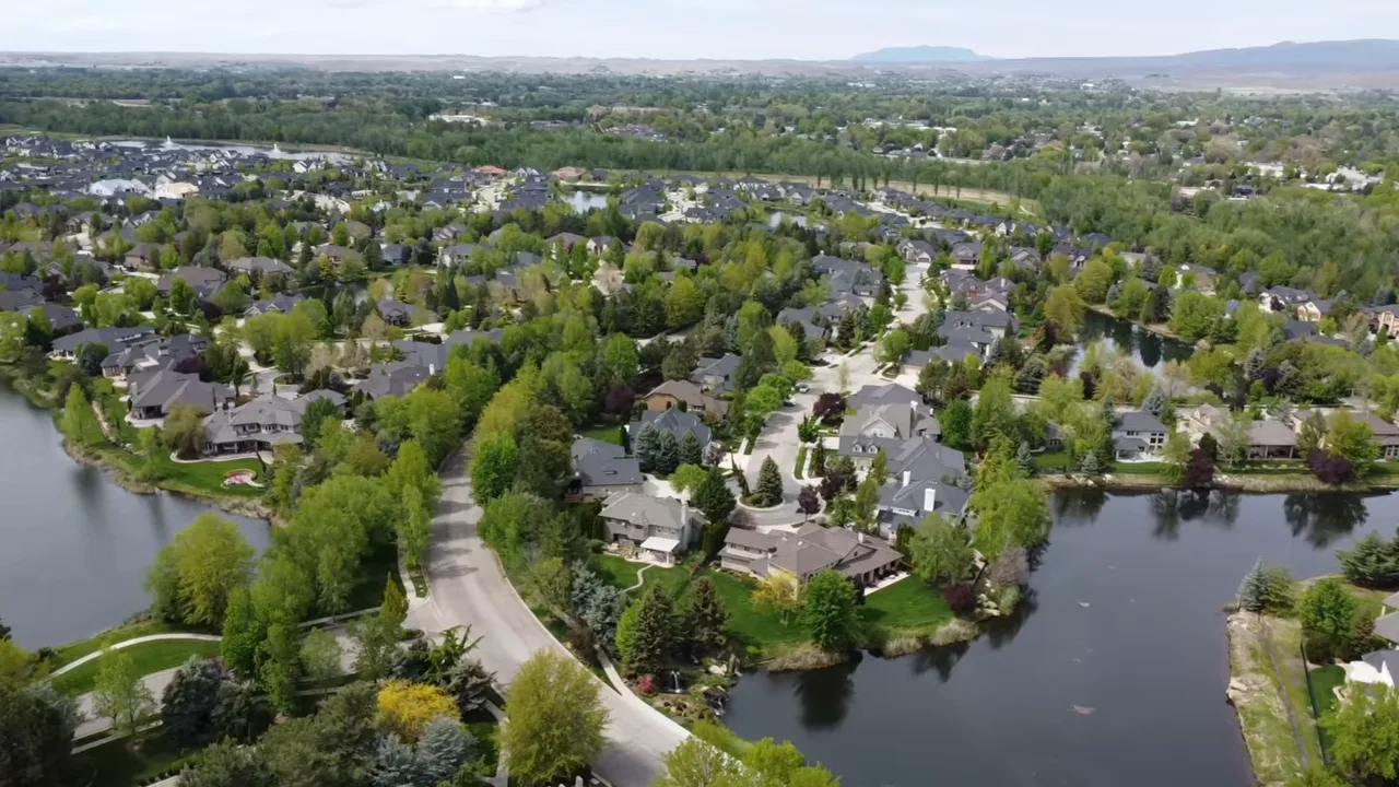 Aerial view of an Eagle, Idaho master-planned neighborhood with houses and a waterway