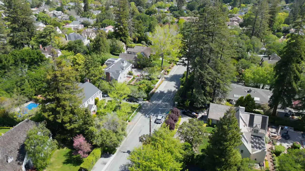 Aerial view of large hillside estates with text showing 5.23 million median sales price