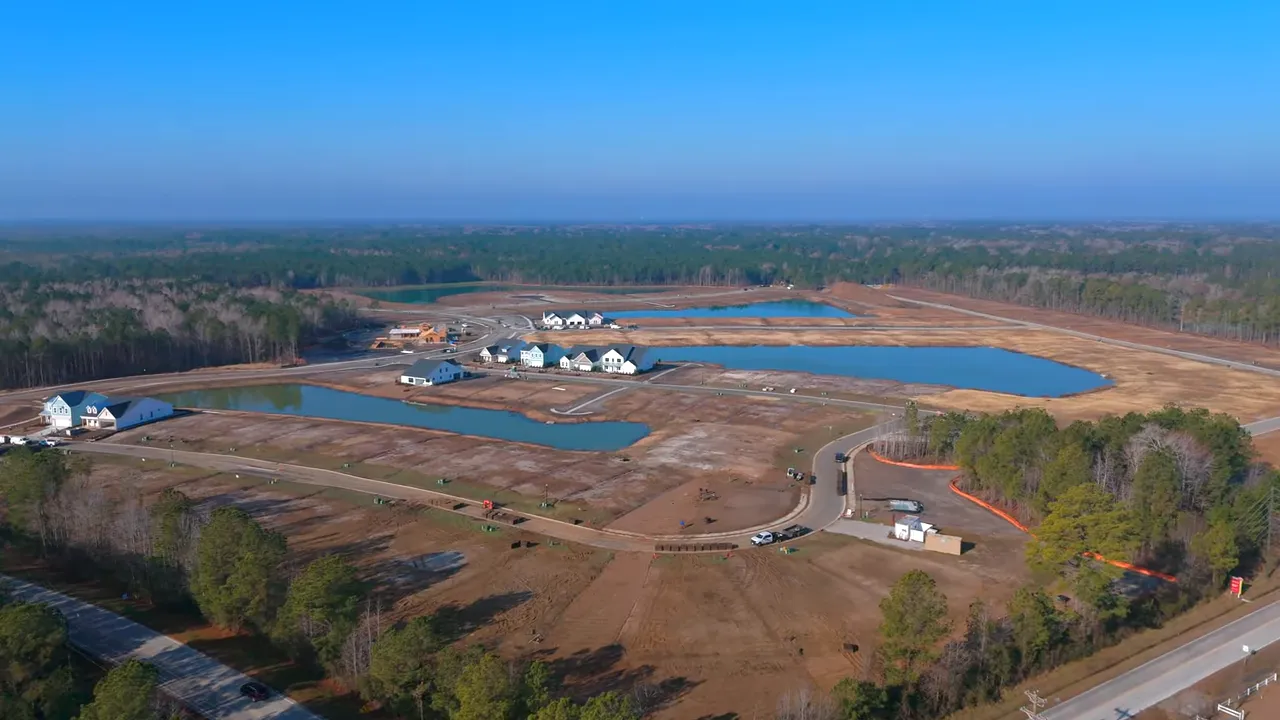 High-resolution aerial of the Marshfield community showing multiple retention ponds, road layout and early-built model homes.