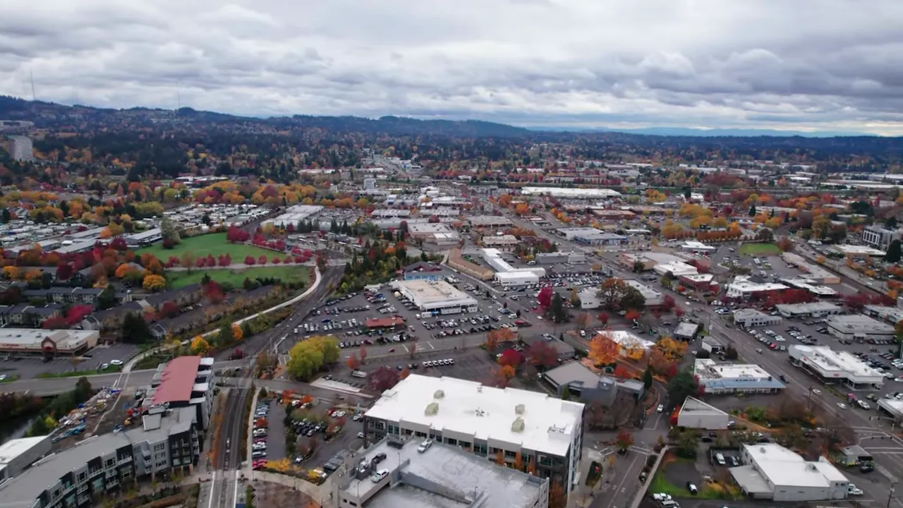 Aerial view of Portland-area neighborhoods and commercial corridors with fall trees