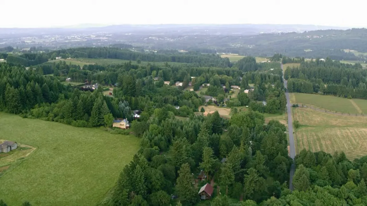 Aerial view of countryside with forests and homes across the Portland metro
