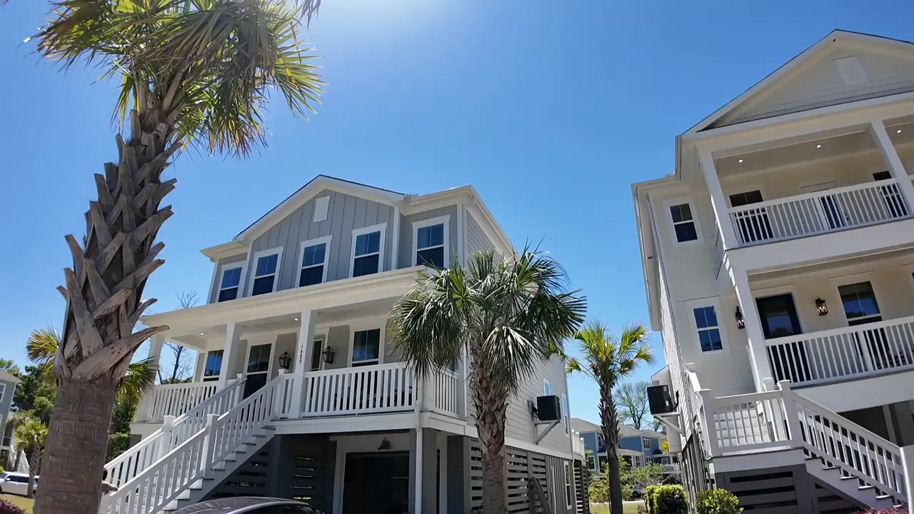 Modern townhome community in Summerville SC with palm trees under a clear blue sky