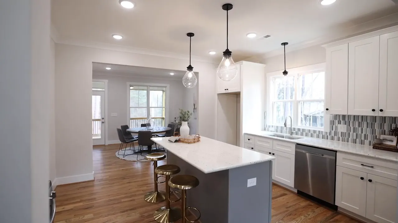 New construction kitchen with island, pendant lights, and white cabinetry