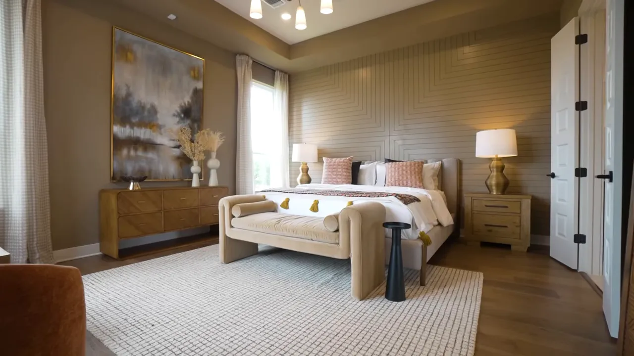 Primary bedroom with tray ceiling bed seating area and tall windows