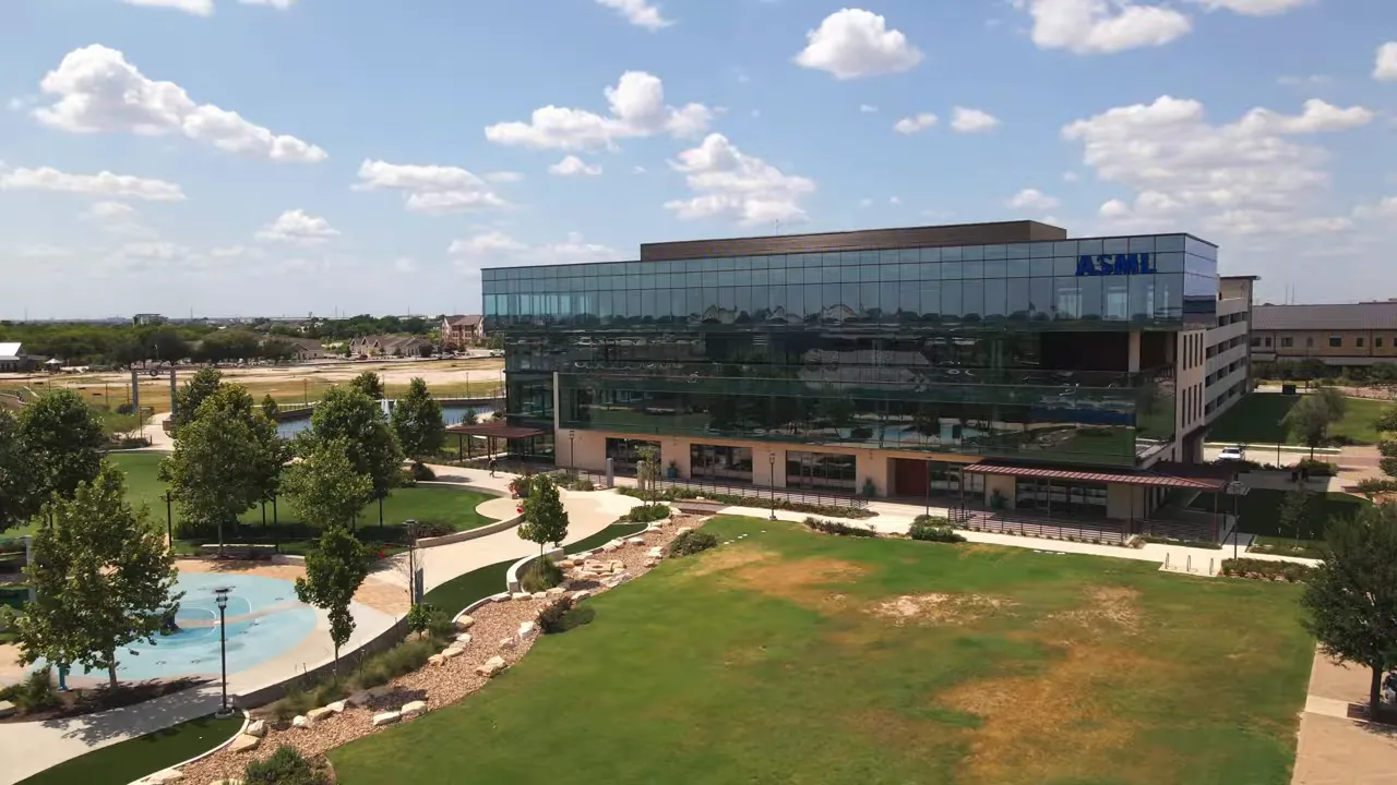 ASML office building in Hutto beside a green lawn and walking paths