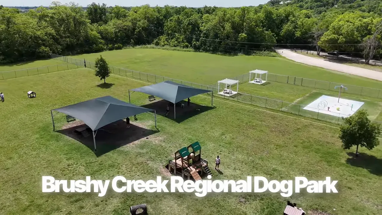 Aerial view of Brushy Creek Regional Dog Park with grassy fields and shade structures