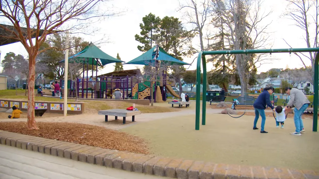 Burton Park playground area with families