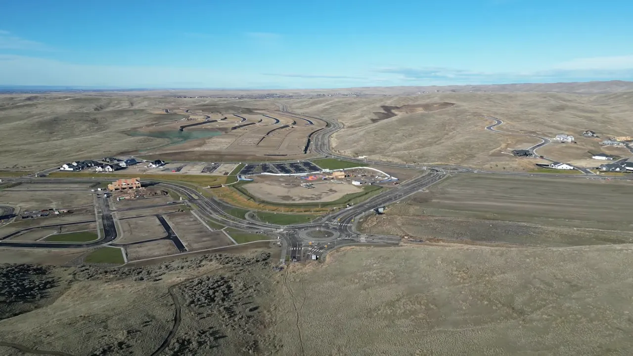 Aerial view centered on the Valnova roundabout and nearby construction site, illustrating the master-plan core and surrounding lot layout.