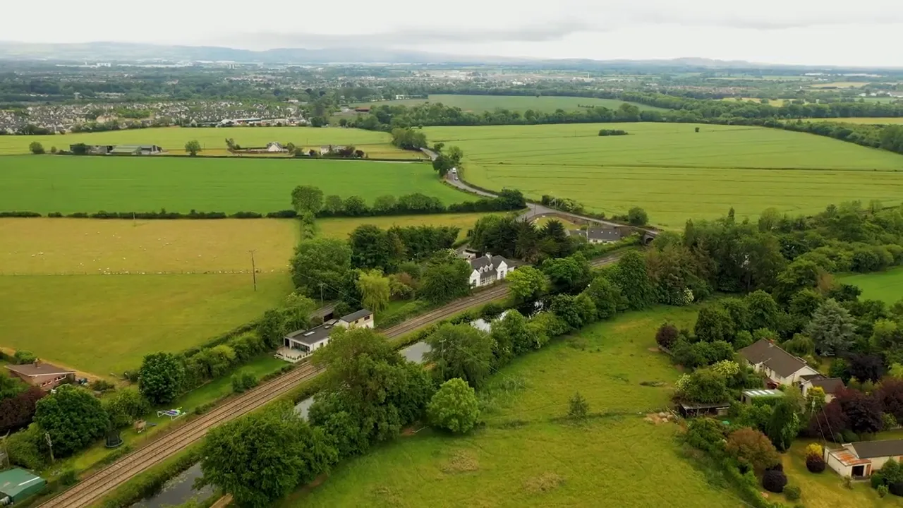 Aerial view of rural homes, fields, and roads in the countryside