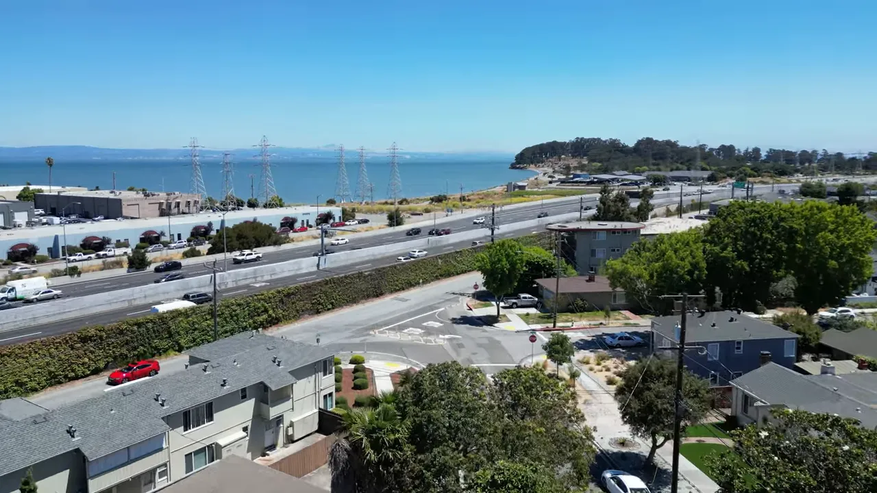 Coastal bay view with highway along the shore and residential buildings in the foreground