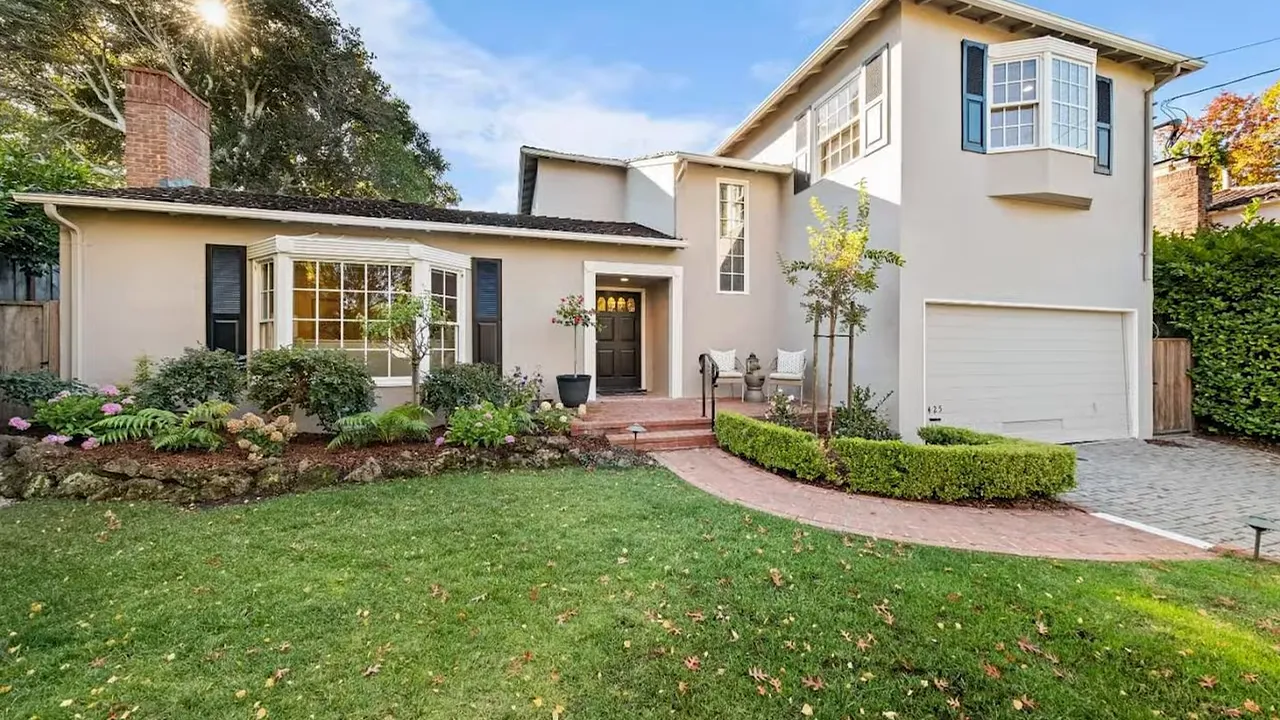 Well-lit exterior of a single-family home with front lawn, entry steps and attached garage