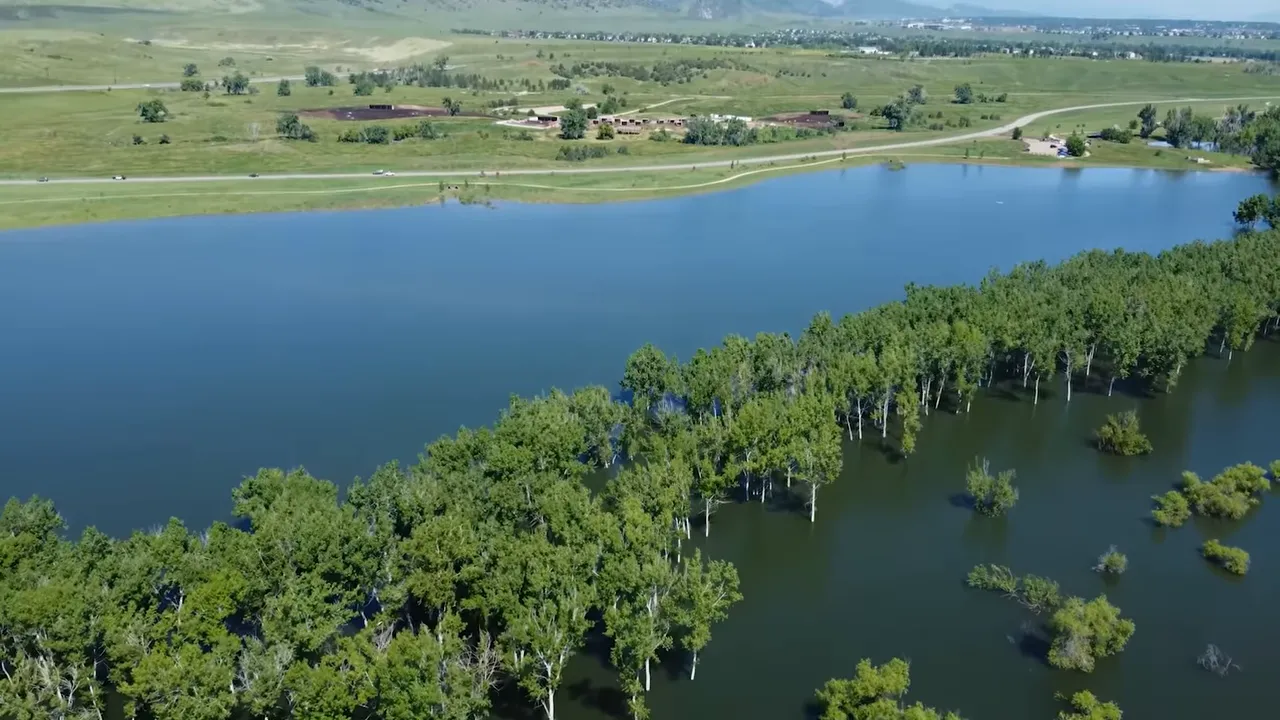 Aerial view of expanded water at chatfield reservoir with flooded tree areas