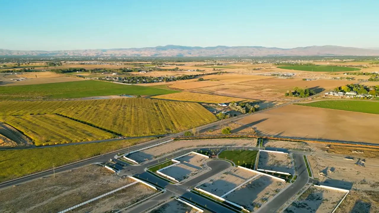 New housing development surrounded by farmland and open fields