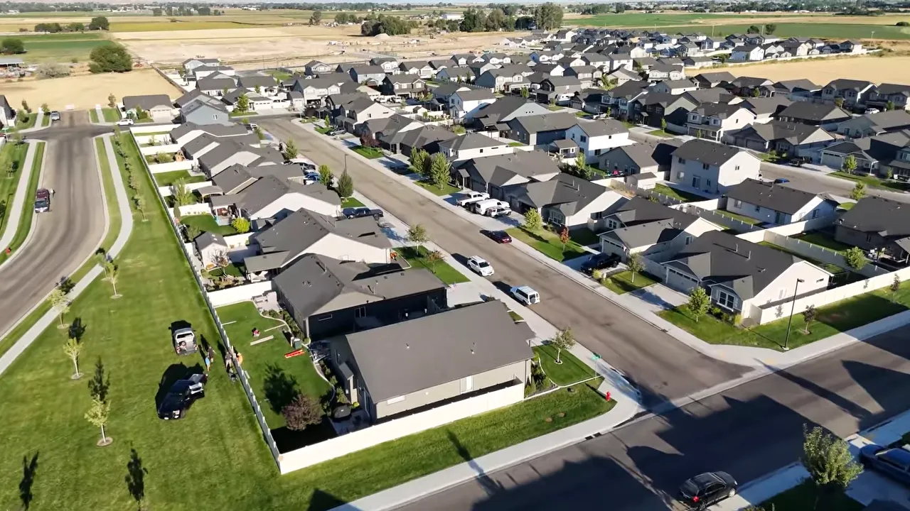 Aerial view of newer homes beside open land
