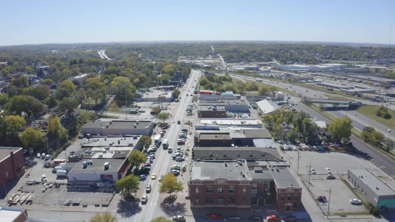 Aerial drone photo of a suburban commercial corridor and surrounding residential neighborhoods in Omaha