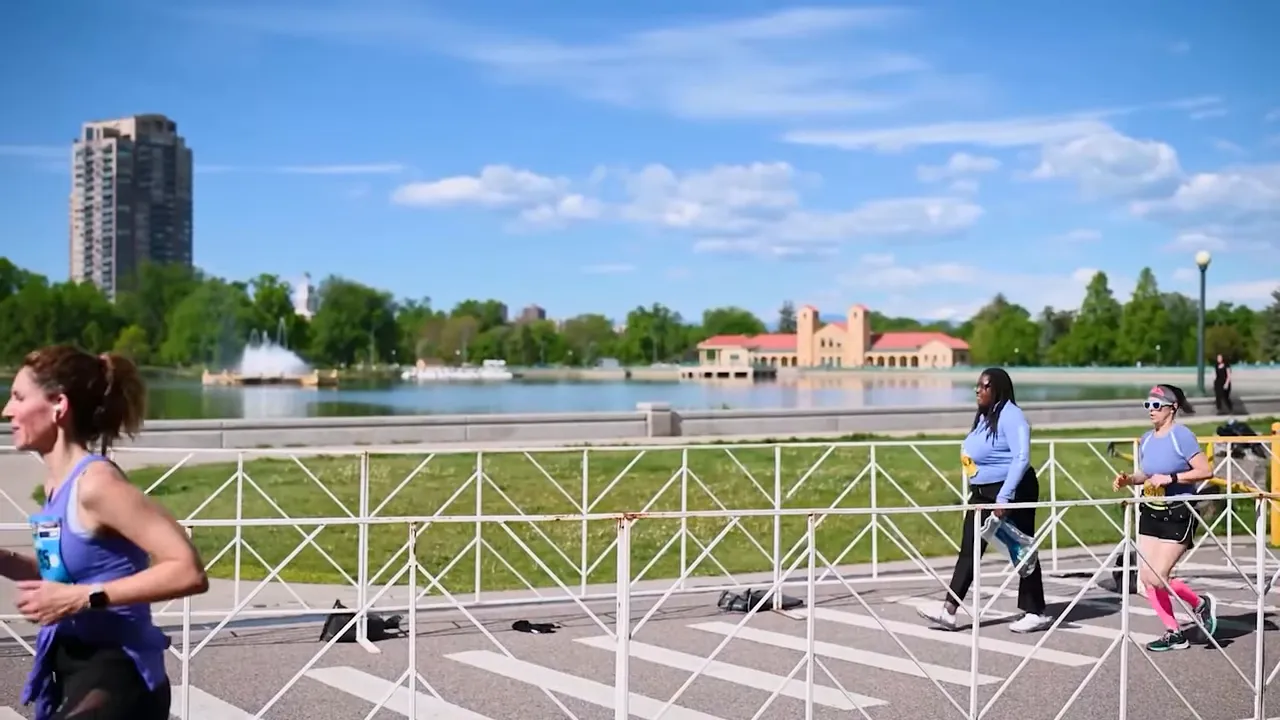 Runners exercising in Denver Colorado near a riverfront walkway on a clear day
