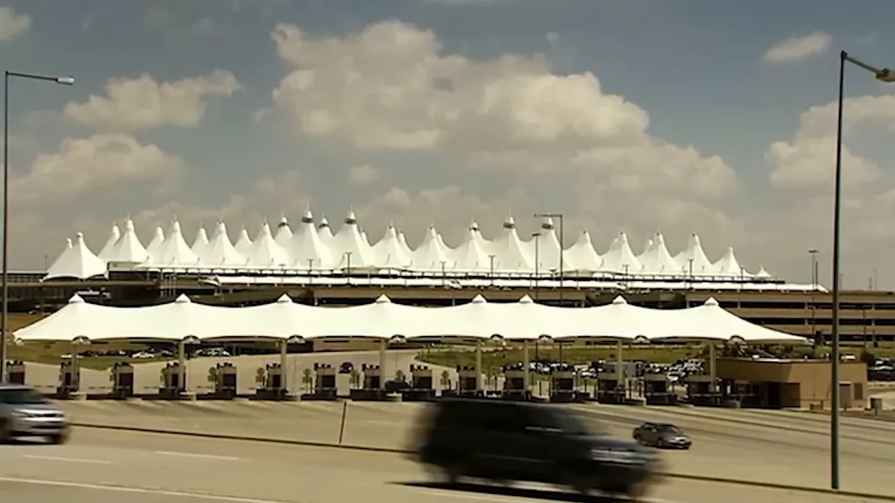 Denver International Airport terminal and gates area under a cloudy sky