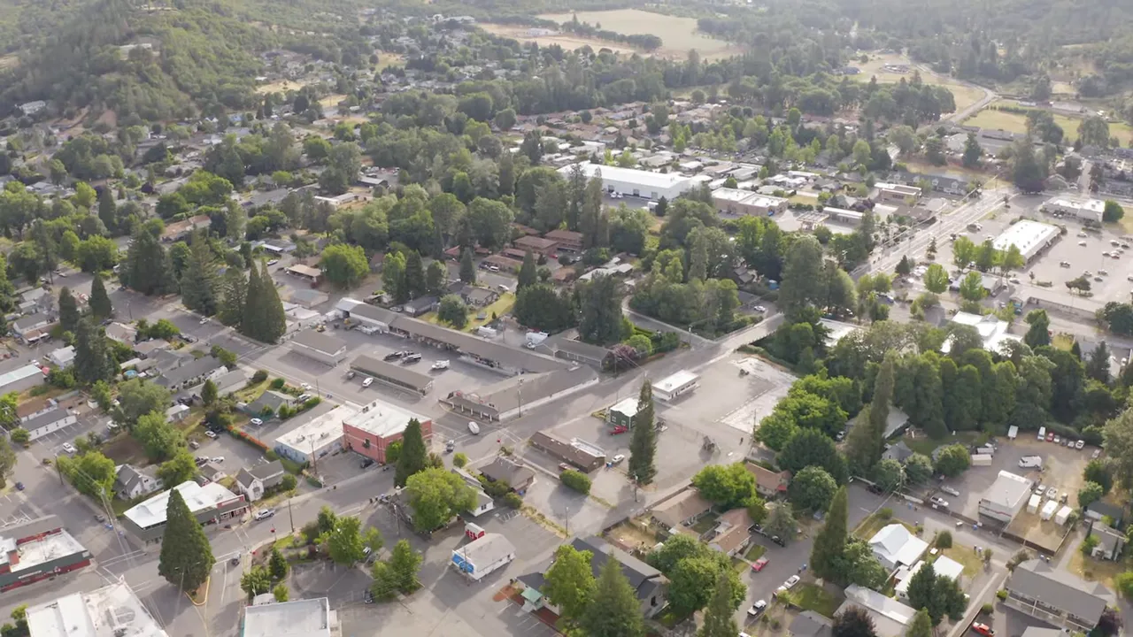 clear aerial photograph of a Southern Oregon town showing streets, homes, and tree cover