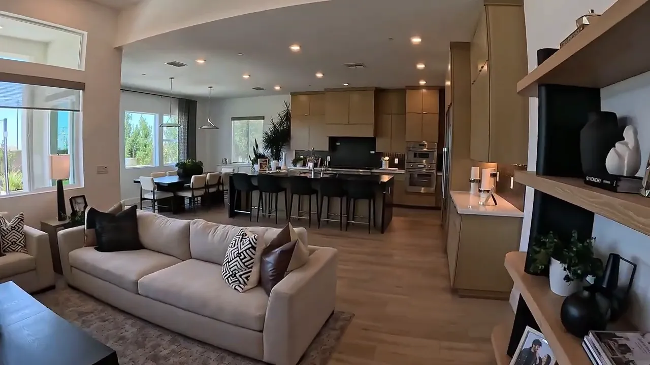 Open kitchen, dining, and living area with high ceilings