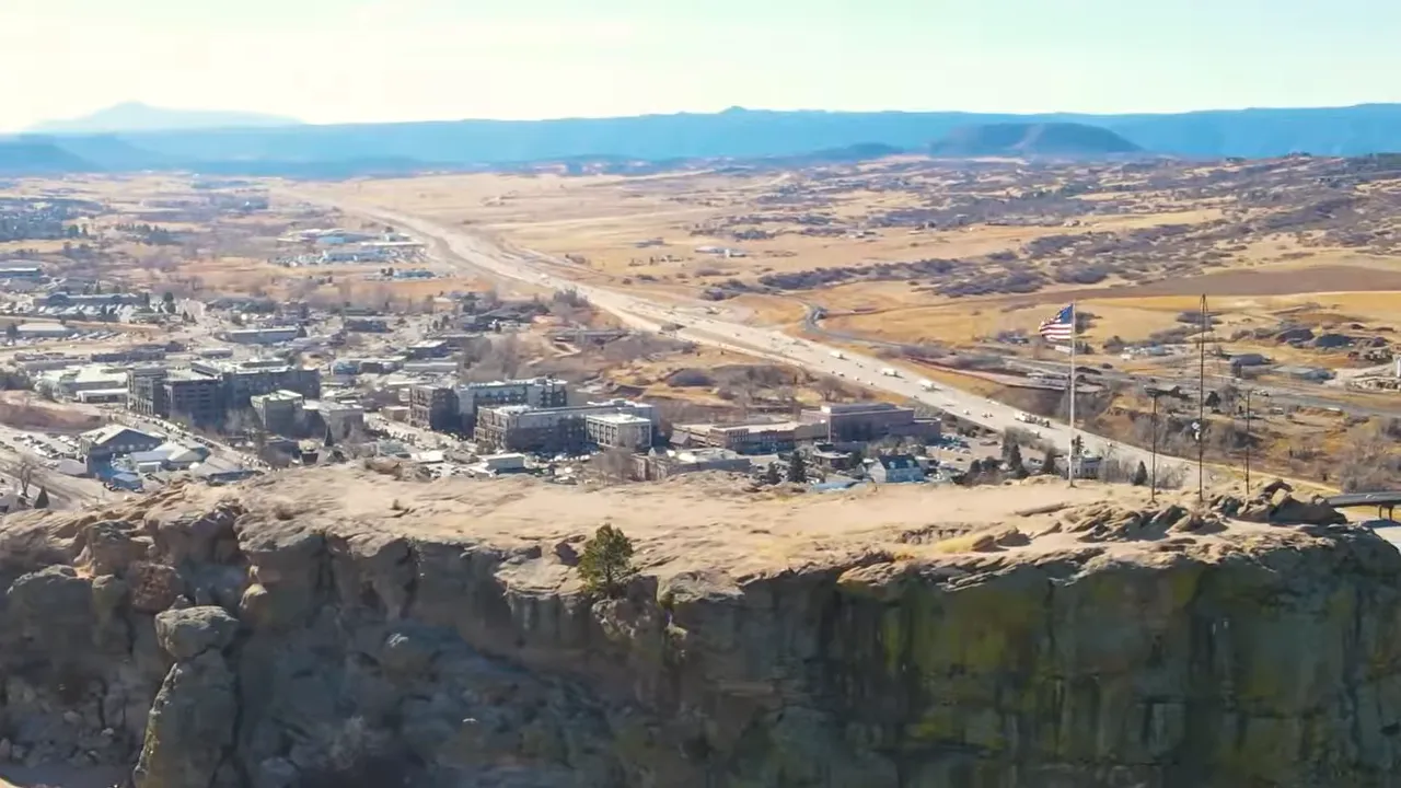 Denver area landscape with plains terrain, highway corridor, and distant mountains