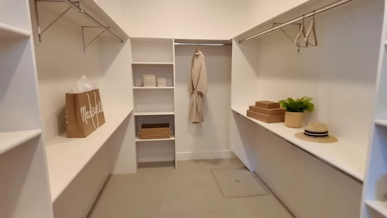 Spacious walk-in closet with multiple shelves, hanging space, and storage bins in a Dry Creek Ranch home
