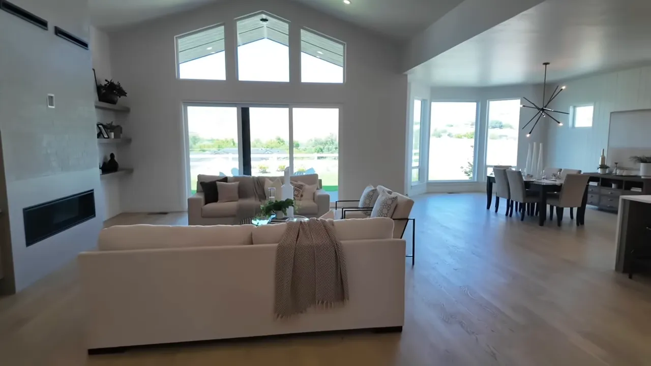 Vaulted living room with large window overlooking lawn and foothills in Dry Creek Ranch home