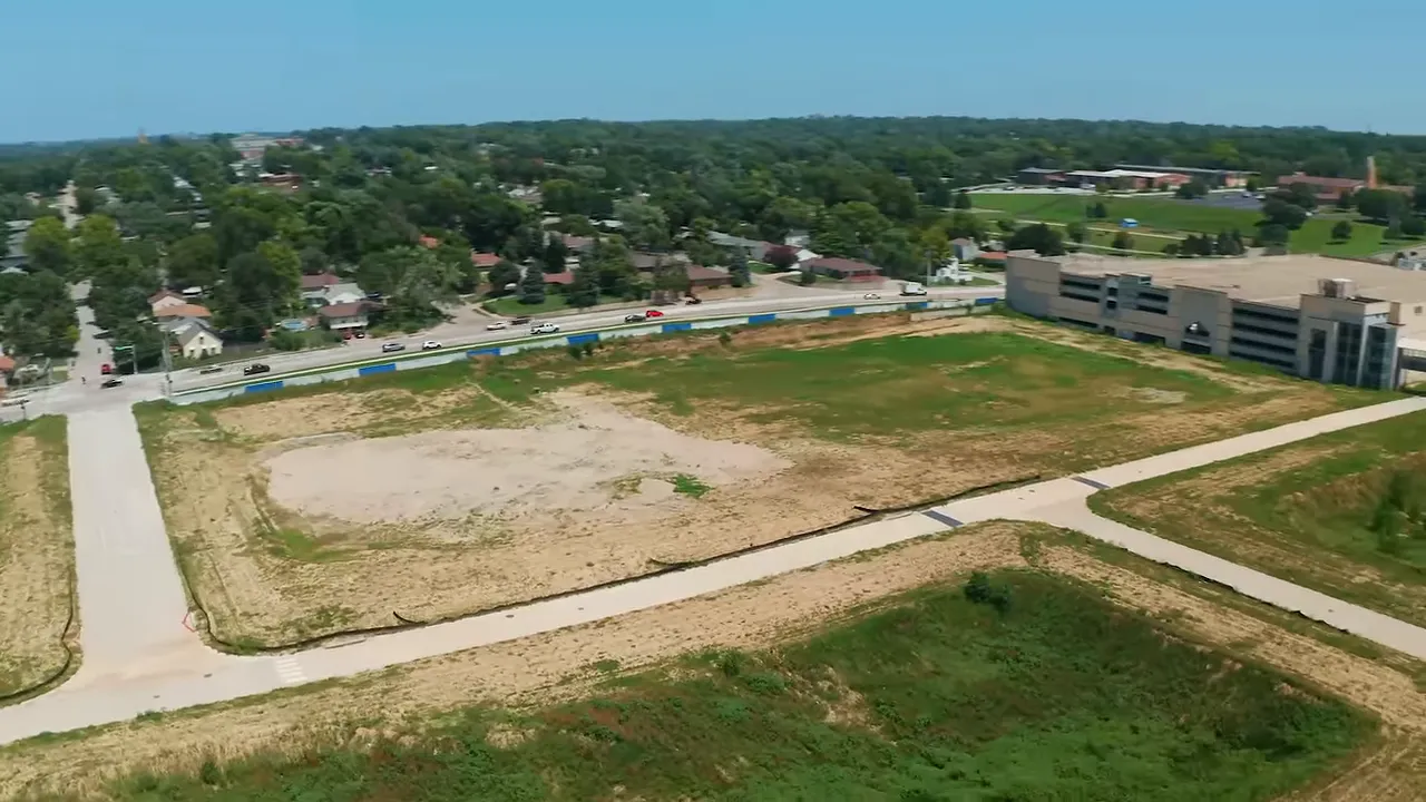 Aerial view of cleared Crossroads redevelopment site with roads and nearby buildings