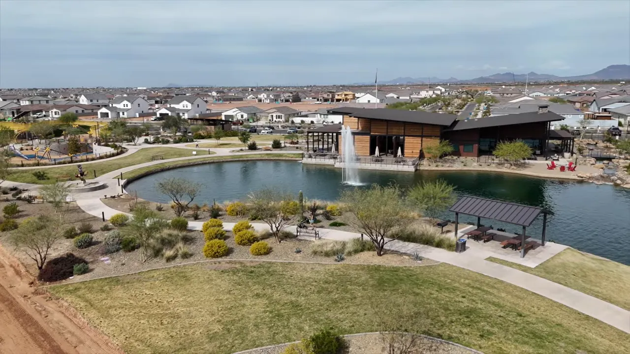 Aerial view of lake, fountain, clubhouse, and walking paths at Blossom Rock